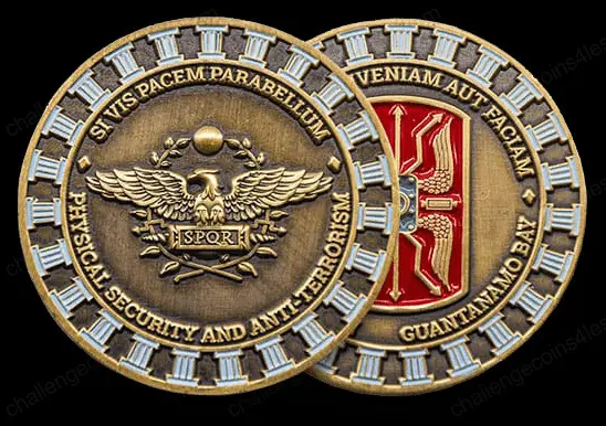 A double-sided military challenge coin with intricate designs. One side has a golden eagle emblem with 'SPQR' and the motto 'Si vis pacem, para bellum,' indicating readiness for peace and war. The other side features a red and gold motif with the phrase 'Venia aut faciam,' and 'Guantanamo Bay' etched below, showcasing a blend of historical and modern military symbolism.