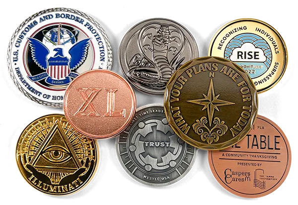 pile of challenge coins with different metal finishes